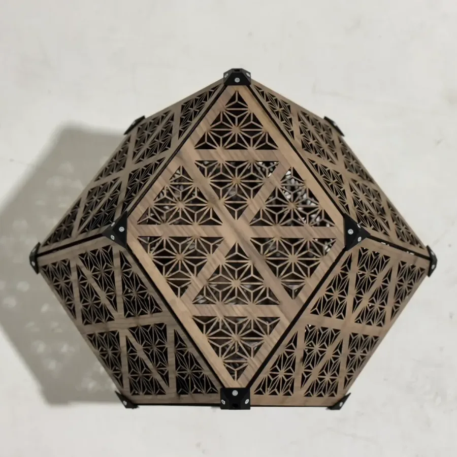 Laser-cut wooden rhombic dodecahedron lamp with patterned faces